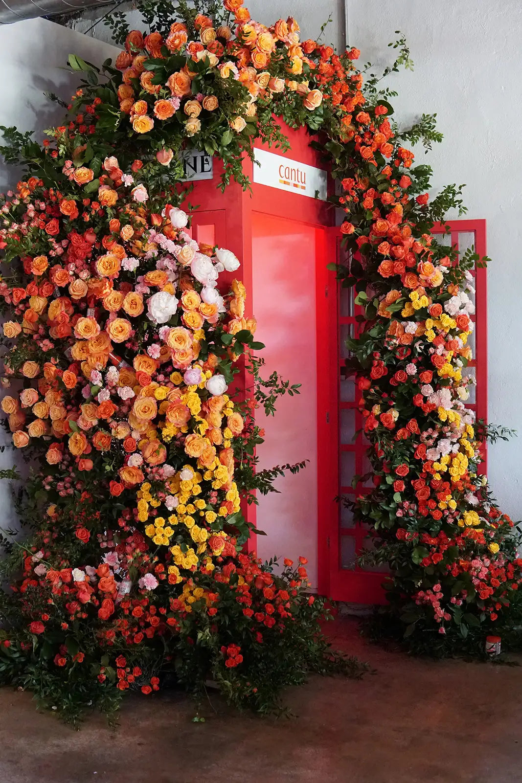 Red telephone box decorated with a vibrant florals