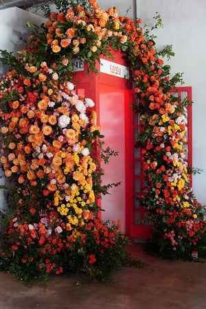 Red telephone box decorated with a vibrant florals