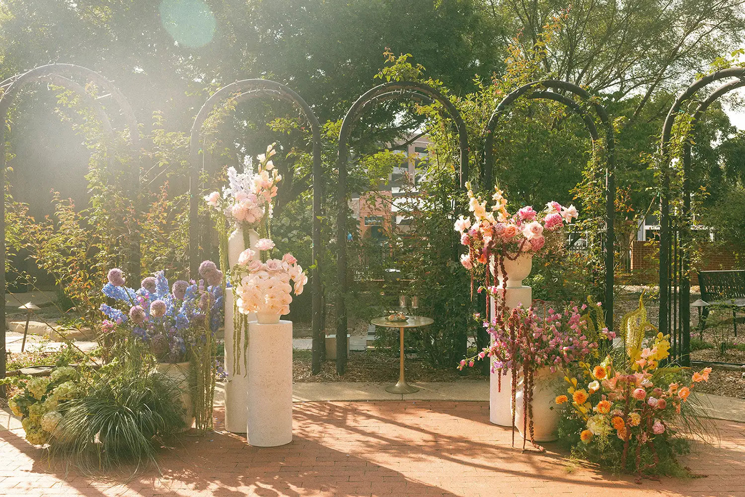 Decorative floral arches with flowers in a garden setting